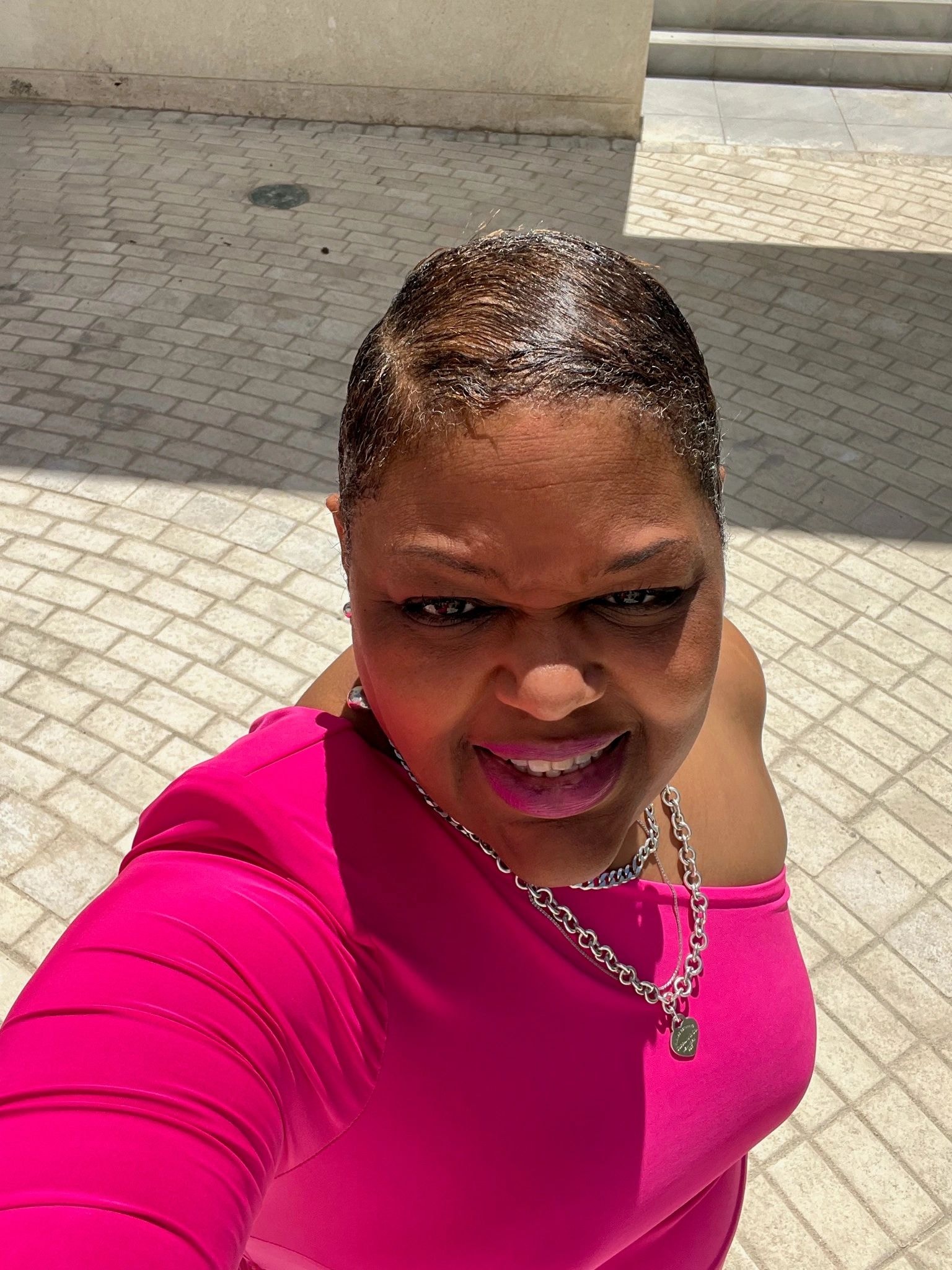 Woman in pink top selfie outdoors